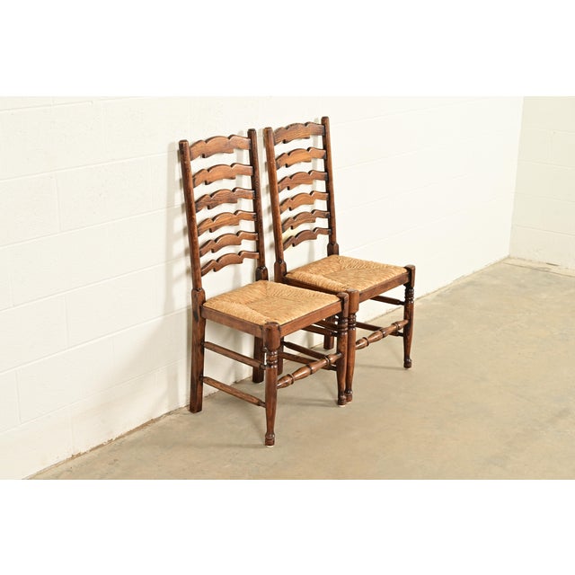 French Country Baker Furniture Style English Country Rustic Carved Solid Oak Ladder Back Dining Chairs With Rush Seats, Pair For Sale - Image 3 of 13
