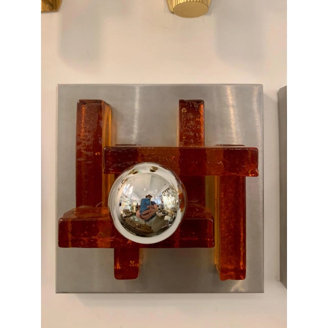 A great pair of sconces composed of thick amber rust color Murano glass and matte steel fixtures. Rewired.