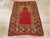 An antique Turkish Anatolian throw rug. The open red niche field is set under golden yellow plain spandrels and within an...