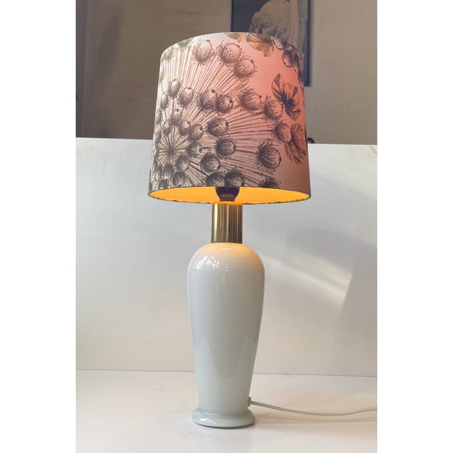 A stylish elegantly crafted scandinavian table light featuring a handmade textile drum shaped shade decorated with opium...