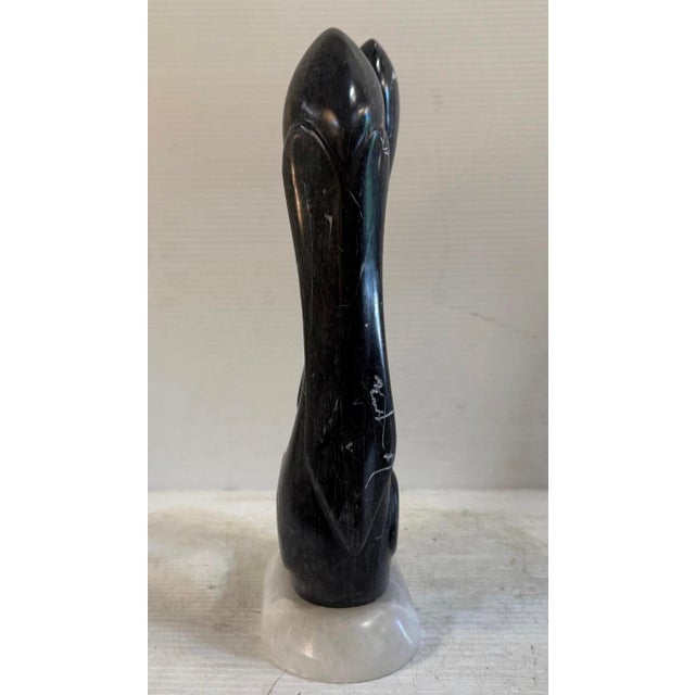 This abstract sculpture is constructed of black and white marble, with a white marble base. It's fluid form and minimalist...