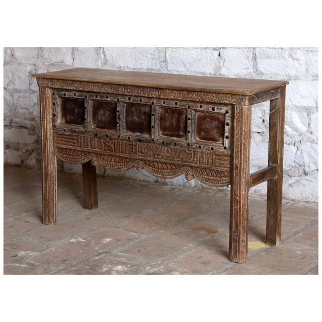 Rich in character and old-world artistry, this vintage carved wood console table features intricate hand-carved detailing...