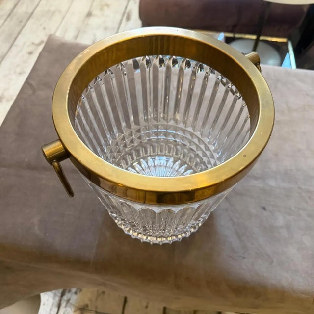 This 1970s Mid-century Modern gold Plated and Heavy Cristal French Wine Cooler is a statement piece that embodies the...