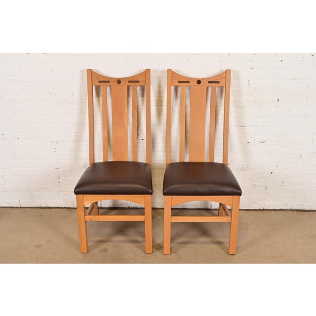 An exceptional pair of Mission or Arts & Crafts style high back side chairs or dining chairs In the manner of Stickley or...