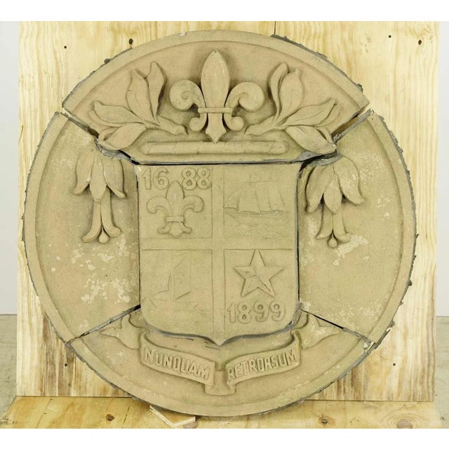 Reclaimed architectural terra cotta stone building medallion. It displays the seal of the city of New Rochelle in New York...