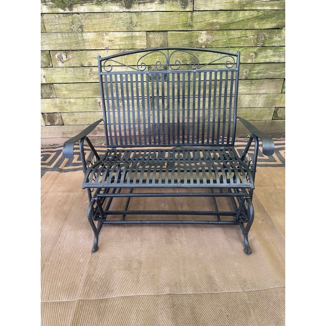 Add charm and motion to your outdoor space with this Woodard Style Wrought Iron Swinging Bench—a beautiful fusion of...