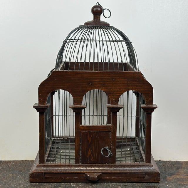 A beautiful decorative cathedral style wood birdcage with pull-out tray and hinged door. Use a decorative object for home...