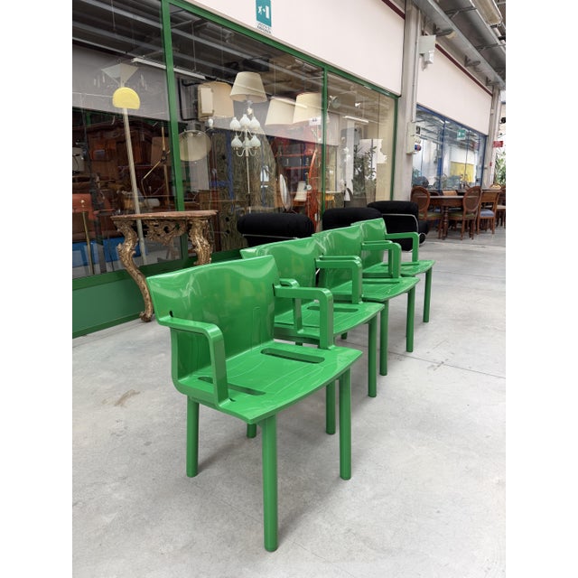 Set of 4 bright green ABS plastic chairs with armrests, designed by Anna Castelli Ferrieri for Kartell in the 1980s. These...