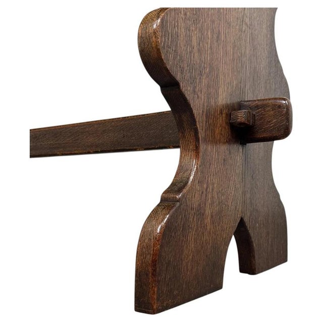 A handsome early 20th-century English refectory-style dining table, finely crafted from oak and distinguished by its...