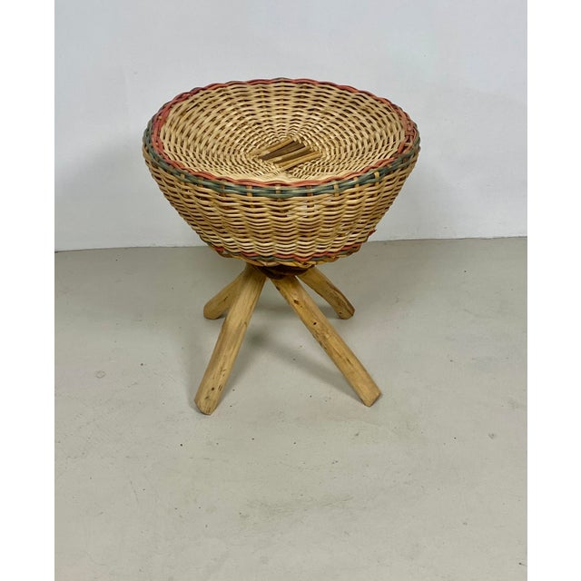 A very pretty wicker stool with a crossed base in exotic wood, elegantly held in place by a braided wicker collar. The...