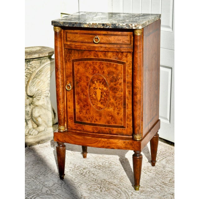Antique (Late 19th Century) Cabinet/Stand has a French Style. The Wood is Burl Wood. Inlaid Burl Wood with a Mable Top....