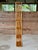 A wonderfully tall and narrow vintage rattan wall shelf or étagère featuring six woven rattan shelves and slender vertical...