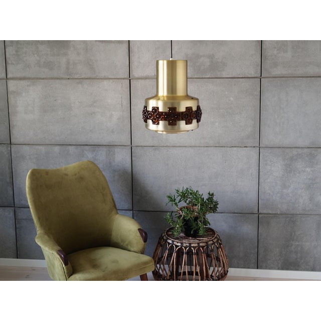 The lamp was made in 1960s, Danish production. Made of glass and metal. The metal is golden, the glass is brown. The...
