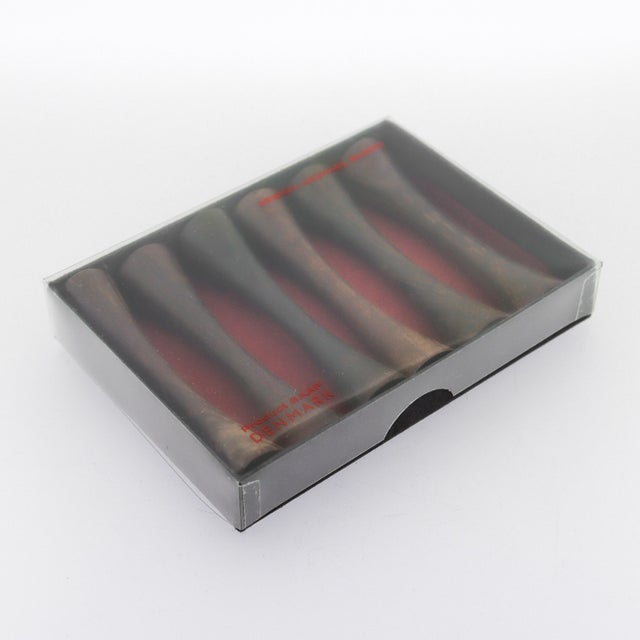 A fine boxed set of Danish Modern knife rests (or chopstick rests). In rosewood (or possibly cocobolo). Produced by...