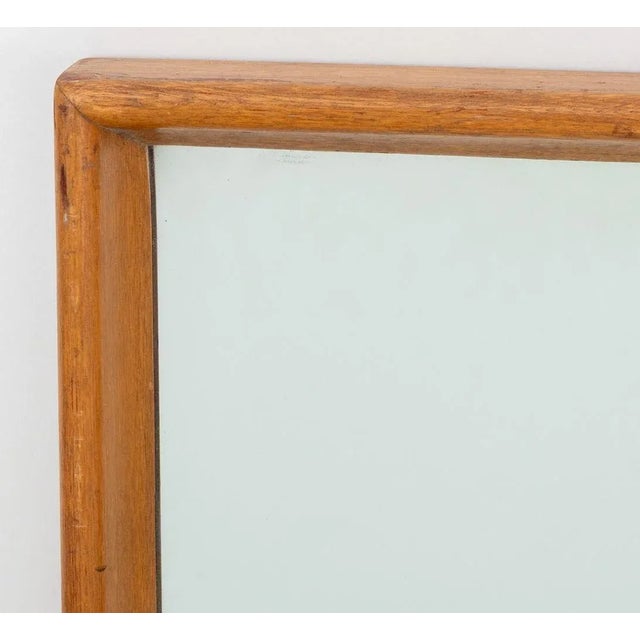 T. H. Robsjohn-Gibbings Mid-Century Modern Walnut Wall Mirror, 20th century. Mirror: 49.5" H x 33.5" W; frame: 51.5" H x...