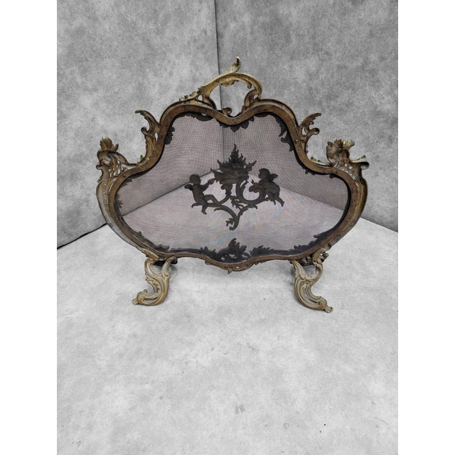 Antique French Louis Style Brass Cherub and Floral Free Standing Fire Screen French brass free standing fire screen with...