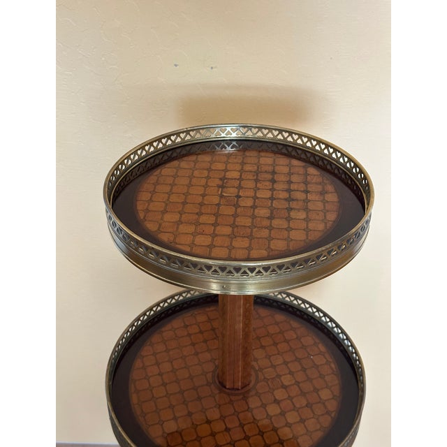 A Fine Louis XVI Style Oval Three Tier Gueridon After The Model by Simon Phillippe Poirier and Martin Carlin. Marquetry is...