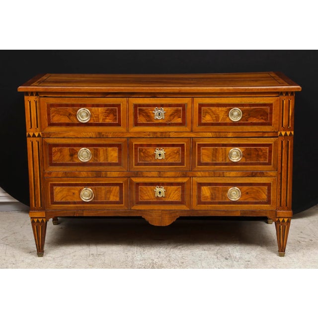 A fine Louis XVI style inlaid commode.