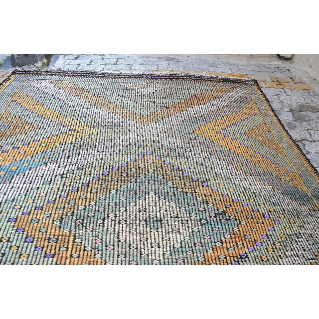 This is a vintage Turkish Anatolian kilim rug from the 1960s. The piece was hand-woven.
