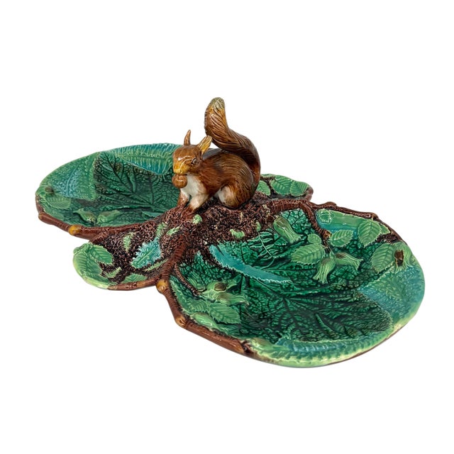 A George Jones Majolica Server, molded with leaves, ferns, and hazelnut blossoms glazed in green, chartreuse, and...