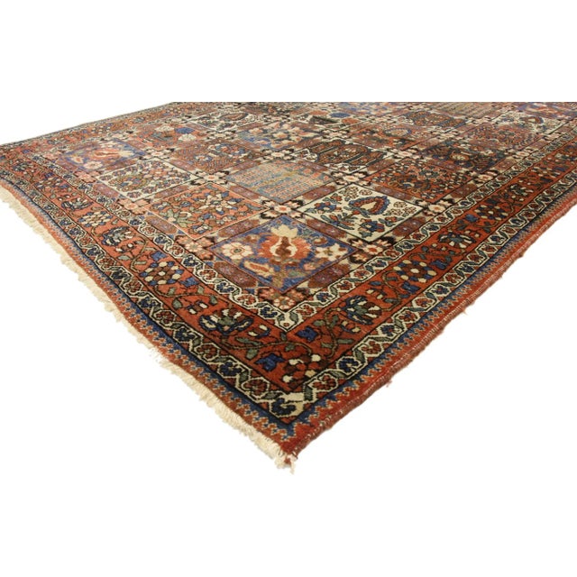 rustic style antique Persian Bakhtiari rug with Four Seasons Garden design. Traditional colors integrated with an intimate...