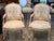 A well-made pair of Louis XV style open armchairs with painted frames in a warm cream finish. The carved frames have the...