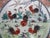 Japanese 20th century porcelain plate, measures 10 1/4". White porcelain hand painted in bold tones of red, green, and...