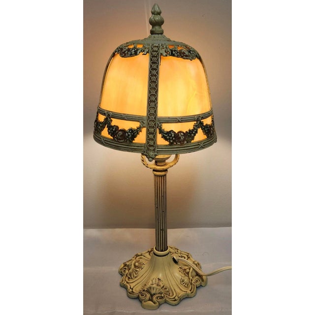 A petite jewel of early 20th-century American lighting, this circa 1920s polychrome slag-glass boudoir lamp is attributed...
