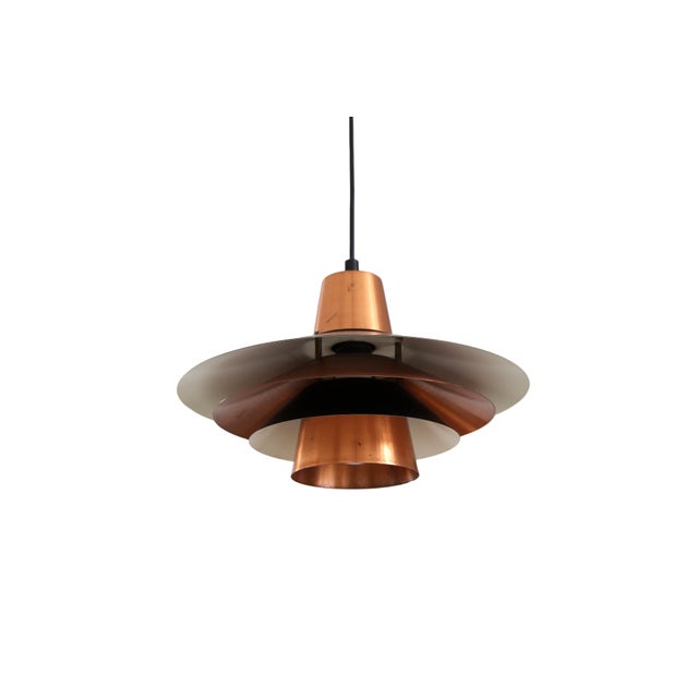 Beautiful Danish design lamp in the style of Louis Poulsen and Fog & Morup. This stylish pendant lamp features copper and...