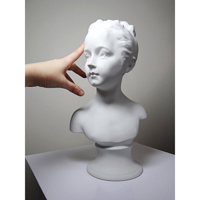 Exquisite antique bust from the early 20th century (1920-1930), on a base, crafted entirely from fine white Limoges...