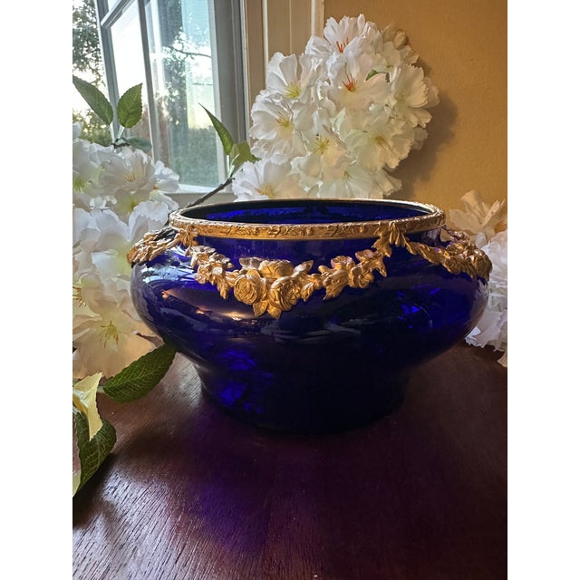 A beautiful antique French jardinière featuring a rich cobalt blue glass body adorned with finely detailed gilt bronze...