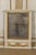A French mid-19th century small antiqued mirror, circa 1850. This mirror is adorned with a swag motif that runs across the...