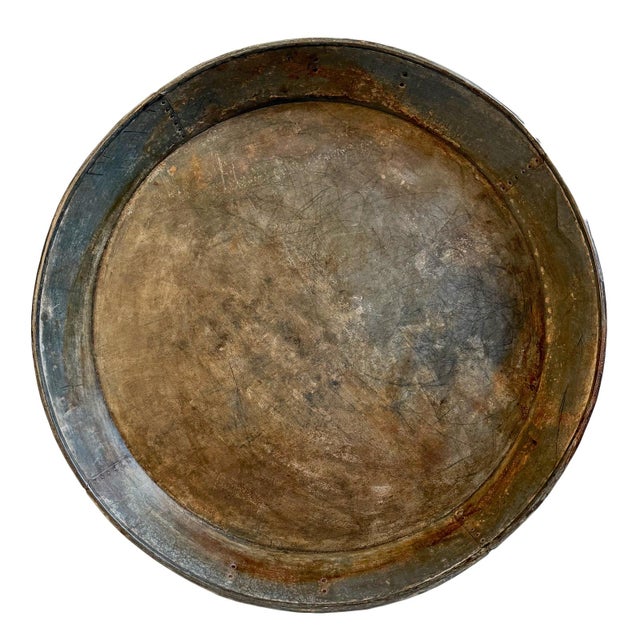Vintage large rustic industrial style round iron tray from India. Hand-formed from heavy-gauge iron, its broad, shallow...