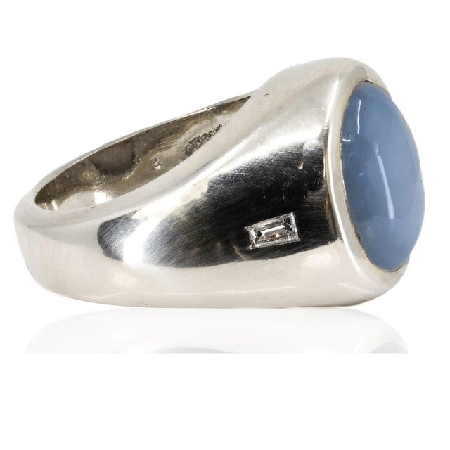 14K Ring with approximate 13.50 carat sky blue star sapphire and 2 baguette cut diamonds weighing approximately 0.12...
