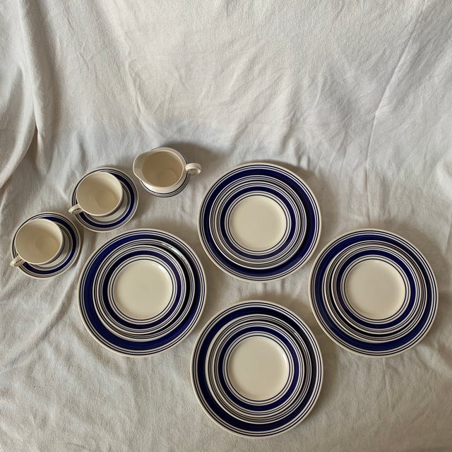 A 12 piece dinnerware set in the Farmstead blue and white pattern by Ralph Lauren Home collection. Signed. Ironstone. Made...