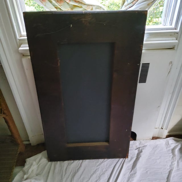 An antique etched mirror depicting figures and garden house. Opposing male and female figures over the garden folly tell a...