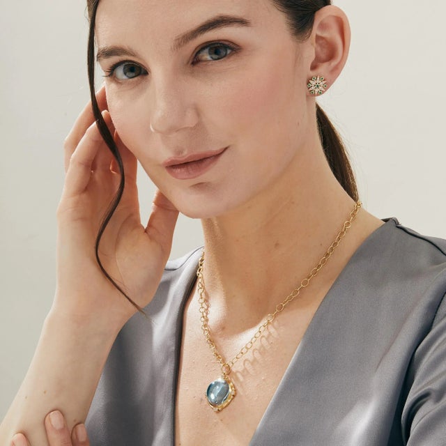 Created in 18 karat yellow gold Blue Topaz 33 carats approx. Diamonds 0.35 carat approx. Chain sold separately Limited...