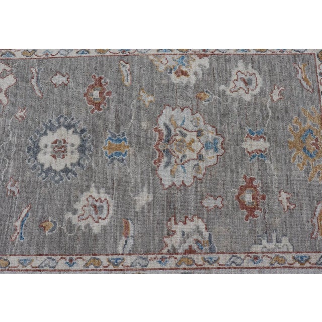 Textile Floral Designed Oushak With Muted Background With Earthy Tones and Soft Blue For Sale - Image 7 of 13