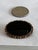 Vintage costume jewelry brooch with a polished oval cabochon center stone having a tortoiseshell pattern. It was engraved...
