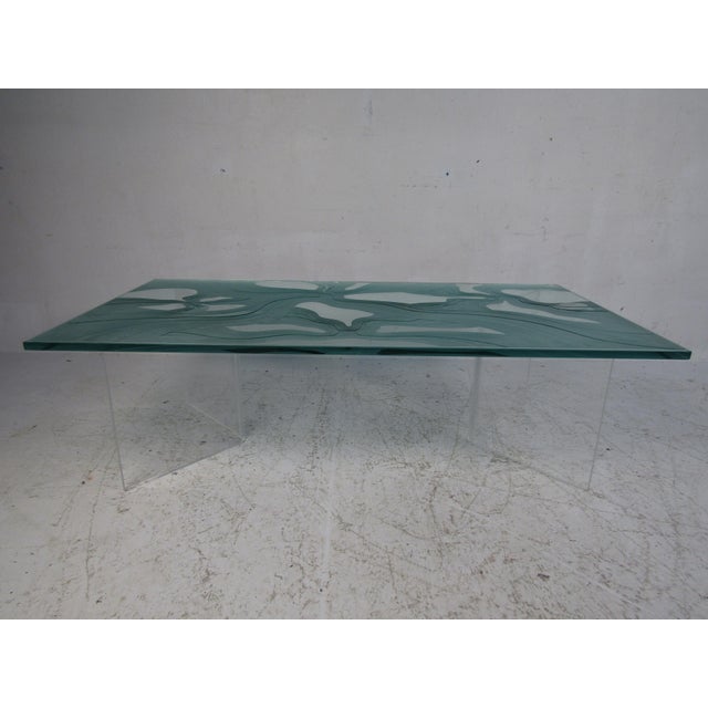A wonderful vintage modern coffee table with two "V" shaped Lucite bases and a unique frosted glass top with beautiful...