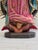 Our Lady of Guadalupe is depicted with hands joined in prayer, a star-decorated green mantle and a rose-colored gown,...