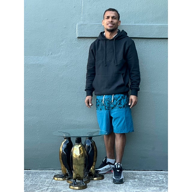 This captivating vintage accent table is a masterful example of Hollywood Regency whimsy, designed in the esteemed manner...