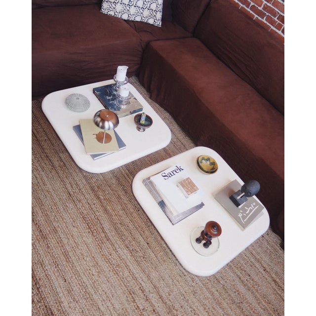 A sculptural post-modern coffee table defined by its soft rectangular top and cylindrical pedestal base. Finished in a...