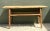 Crafted with a minimalist, functional silhouette, this vintage console table is built from solid wood featuring a warm,...