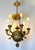 This antique chandelier is an example of the Empire style, constructed from heavy cast bronze with a finely chased ormolu...