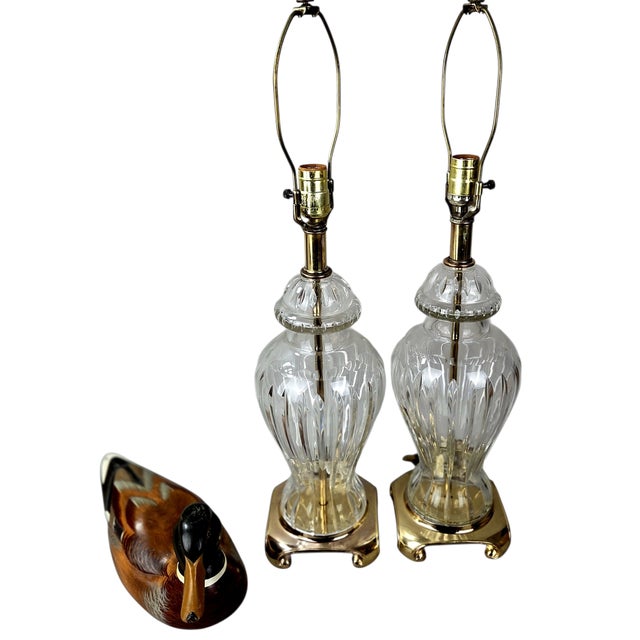 A striking matched pair of circa 1920s European cut crystal table lamps, featuring beautifully proportioned urn-form...