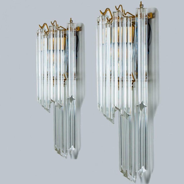 Pair of eautiful triangle shaped glass wall sconces featuring multiple long crystal clear glass tube-like rods, with brass...
