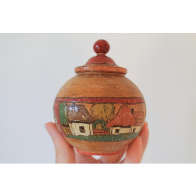 Vintage hand painted lidded wooden jar featuring houses and floral motif. No makers mark. Some age wear.