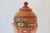 Vintage hand painted lidded wooden jar featuring houses and floral motif. No makers mark. Some age wear.