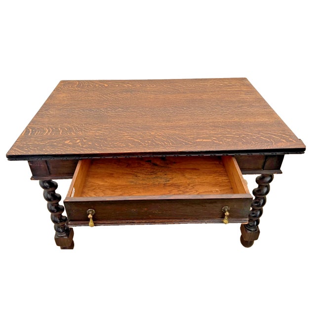 Jacobean Revival library desk. Expertly crafted from oak, this piece features a stunning quarter-sawn Tiger oak top with...